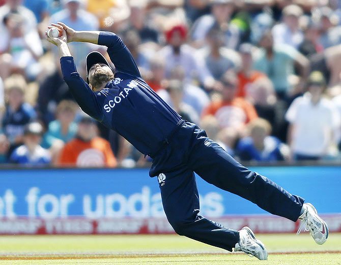 Scotland's Preston Mommsen takes a catch to dismiss England batsman Eoin Morgan during their match in Christchurch on February 23