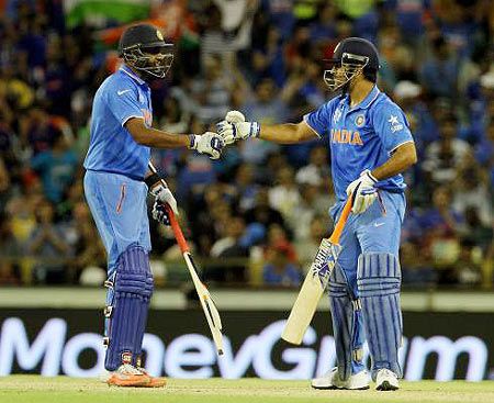 India's Ravichandran Ashwin and Mahendra Singh Dhoni celebrate after winning their match against the West Indies on Friday