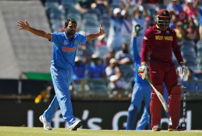 India's bowler Mohammed Shami (left) appeals unsuccessfully for the wicket of West Indies batsman Chris Gayle during their World Cup match in Perth