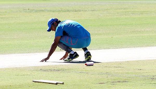 Mahendra Singh Dhoni inspects the pitch