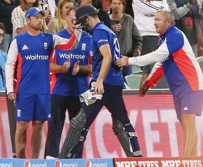 England batsman Chris Woakes is consoled as he walks off the field following their loss to   Bangladesh 