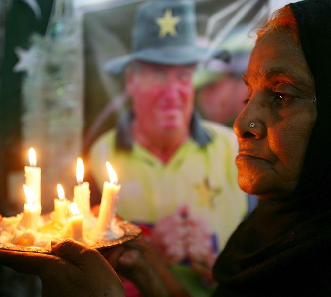 Mourners hold a candle light vigil for slain cricket coach Bob Woolmer