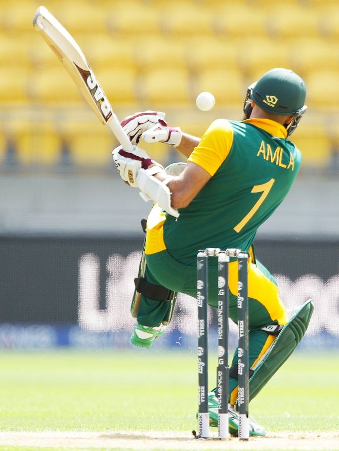 Hashim Amla of South Africa is struck by a delivery from Mohammad Naveed 