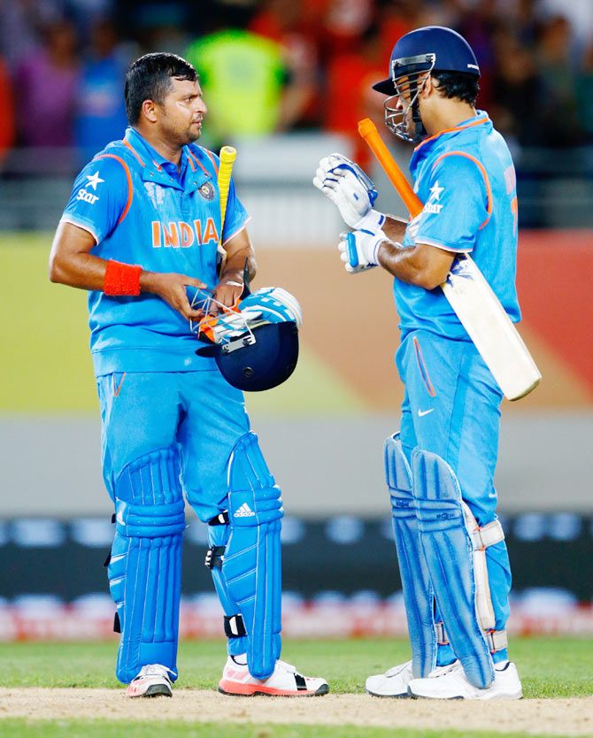 India's Suresh Raina (left) and Mahendra Singh Dhoni celebrate at the end of their World Cup match against Zimbabwe at Eden Park in Auckland on Saturday