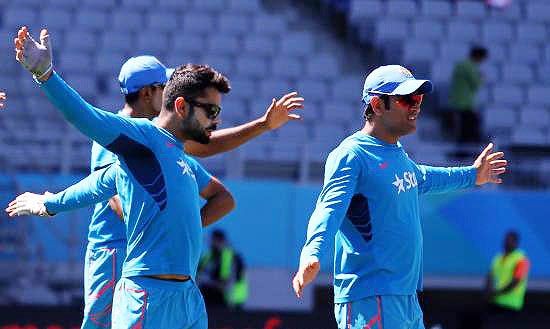 India's Virat Kohli and Mahendra Singh Dhoni warm-up prior to the start of their ICC World Cup Pool B match against Zimbabwe at the Eden Park stadium in Auckland on Saturday