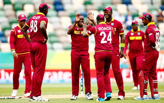 Jerome Taylor of West Indies (centre) is congratulated after claiming the wicket of Khurram Khan of the United Arab Emirates during their 2015 ICC Cricket World Cup match at McLean Park in Napier on Sunday