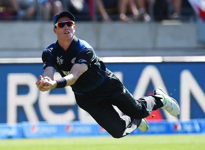 Adam Milne of New Zealand goes aeriel to take a catch and dismiss England captain Eoin Morgan during their match at Wellington Regional Stadium on February 20