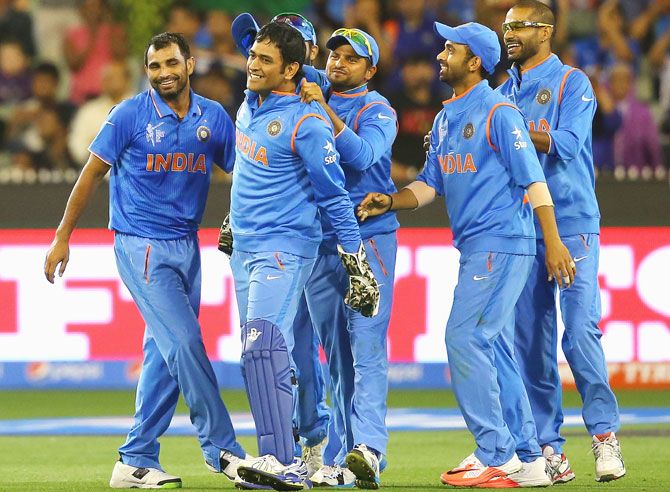 MS Dhoni of India is congratulated by teammates