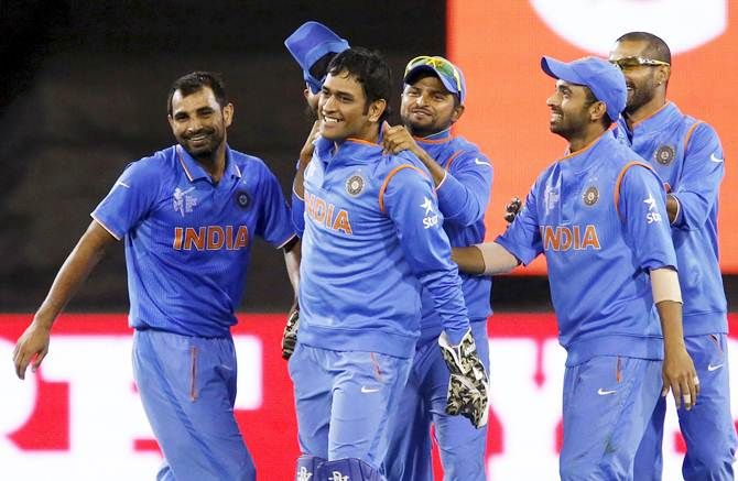 Mahendra Singh Dhoni celebrates with his India teammates