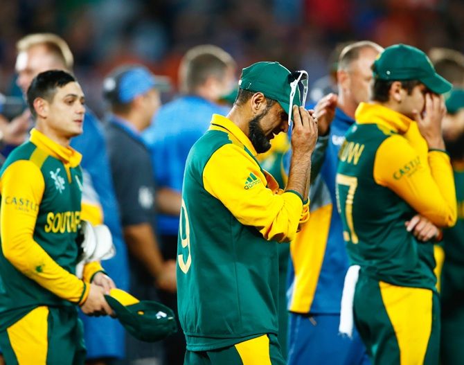 Imran Tahir of South Africa, left, shows his dejection