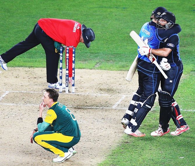 Dale Steyn is heartbroken as Daniel Vettori and Grant Elliott celebrate New Zealand's maiden entry into a World Cup final. Photograph: Hannah Peters/Getty Images