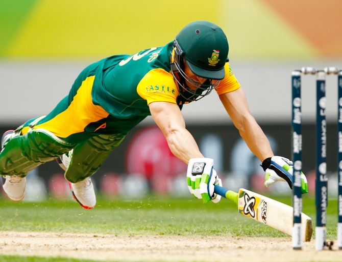 Faf du Plessis dives to make his crease. Photograph: Phil Walter/Getty Images