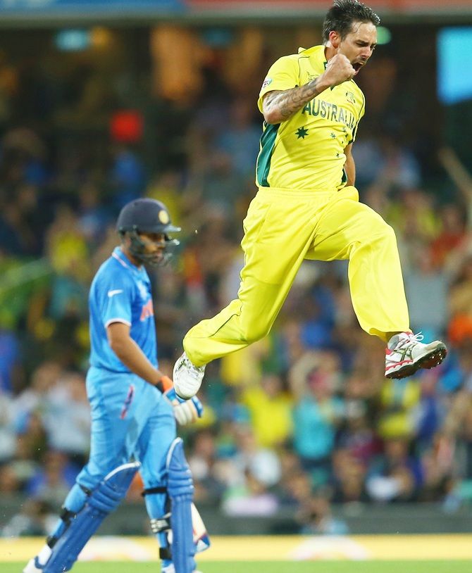 Mitchell Johnson celebrates in typical style after taking Rohit Sharma's wicket. Photograph: Mark Kolbe/Getty Images