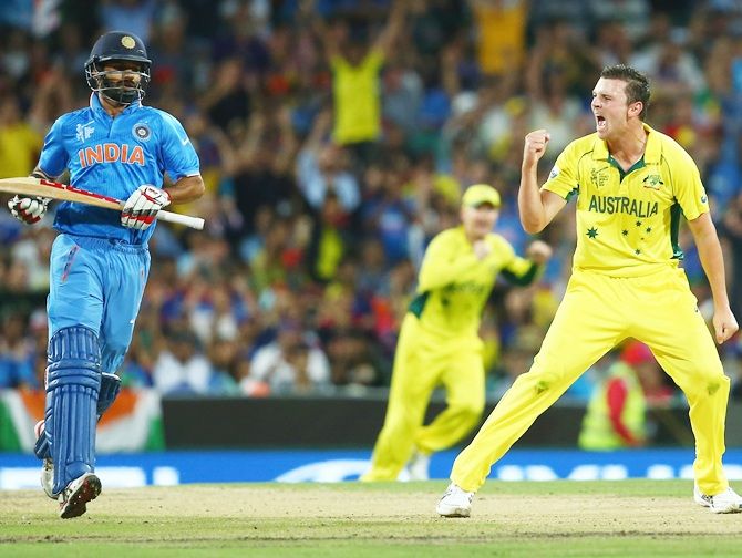 Shikhar Dhawan makes his way to the hut as Josh Hazlewood celebrates the first Indian wicket. Photograph: Mark Kolbe/Getty Images