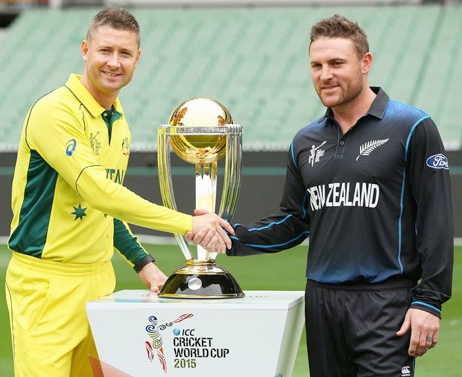 Captains Michael Clarke, left, of Australia and Brendon McCullum of New Zealand pose with the World Cup trophy