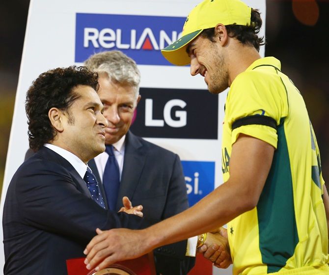 Mitchell Starc receives the Player of the Tournament medallion from Sachin Tendulkar. Photograph: Mark Kolbe/Getty Images