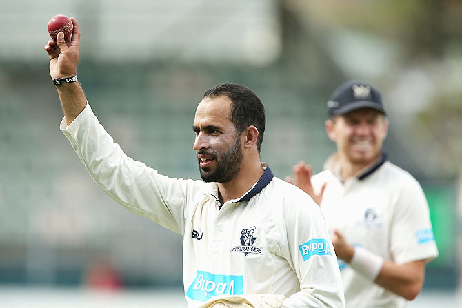 Fawad Ahmed of Victoria walks off holding the ball up high after taking eight wickets during day two of the Sheffield Shield final match against Western Australia at Blundstone Arena on March 22 in Hobart