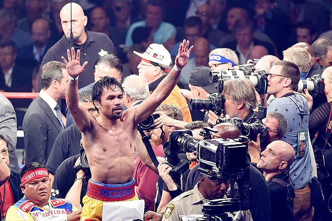 Manny Pacquiao gestures to the crowd after losing to Floyd Mayweather Jr. 