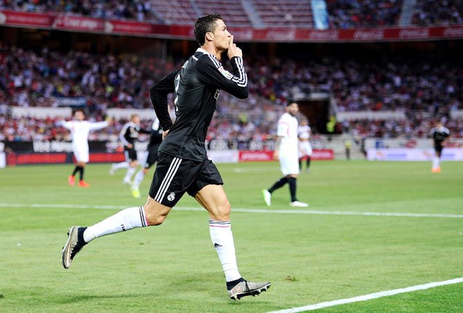 Cristiano Ronaldo of Real Madrid celebrates after scoring his team's 3rd goal during their La Liga match against Sevilla FC at Estadio Ramon Sanchez Pizjuan in Seville on Saturday