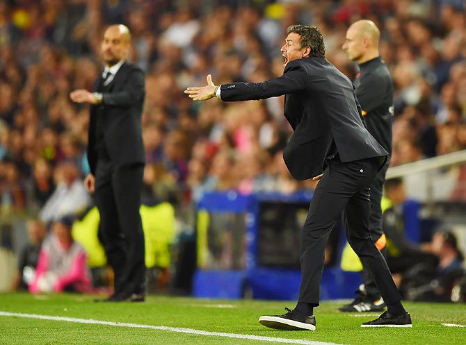 Barcelona coach Luis Enrique (right) directs his players as Bayern coach Josep Guardiola looks on