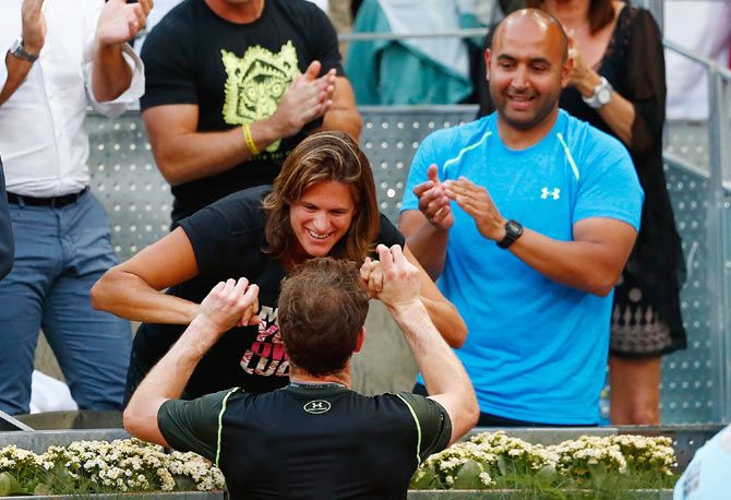 Andy Murray celebrates with coach Amelie Mauresmo after defeating Rafael Nadal in the Madrid Open final