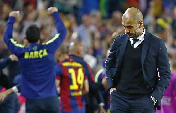 Bayern Munich coach Pep Guardiola looks dejected as Barcelona celebrate after winning their Champions League semi-final first leg at Camp Nou on Wednesday