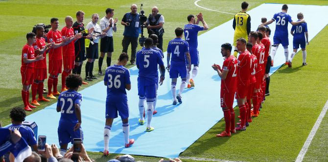 Liverpool players form a guard of honour as English Premier League Champions Chelsea take the field before their match at Stamford Bridge on May 10