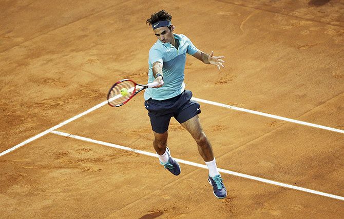 Switzerland's Roger Federer plays a return against Uruguay's Pablo Cuevas