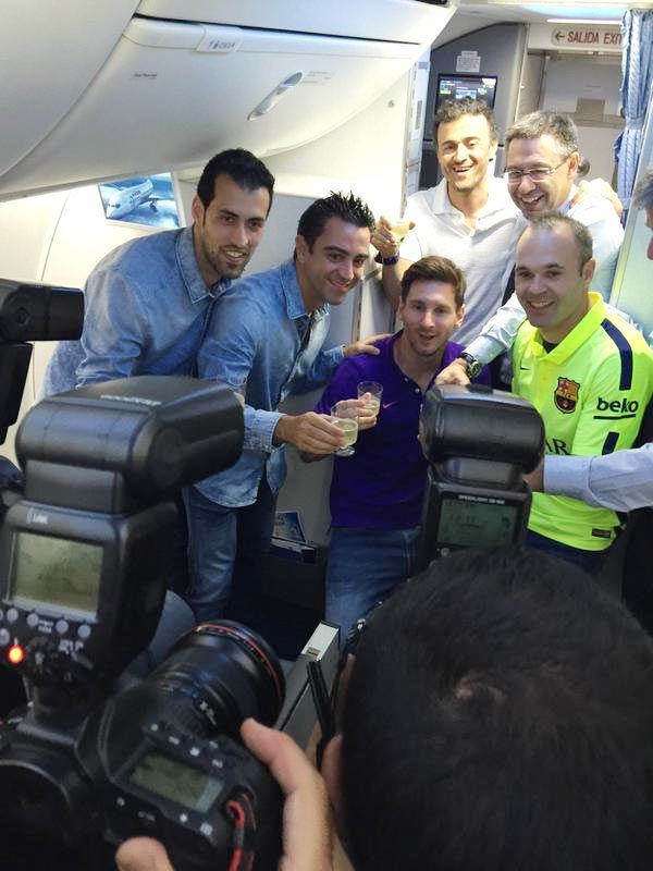 Barca president Josep Maria Bartomeu and coach Luis Enrique celebrate with the team's four capitans, Xavi Hernandez, Lionel Messi, Sergio Busquets and Andres Iniesta
