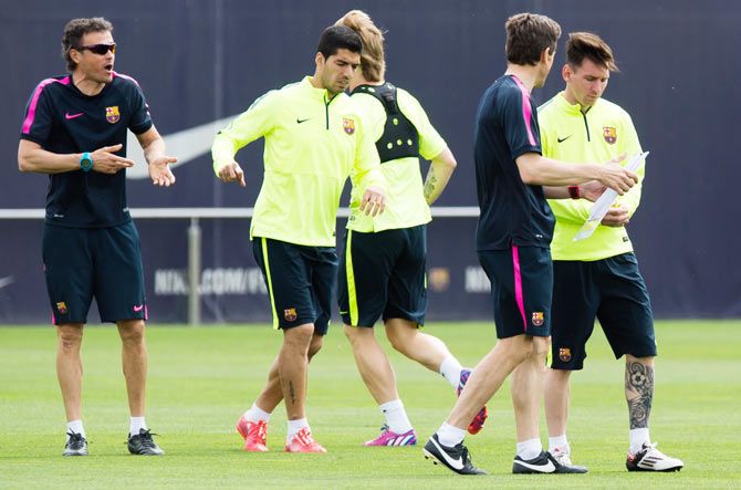 Barca coach Luis Enrique (left) at a training session with Luis Suarez and Lionel Messi