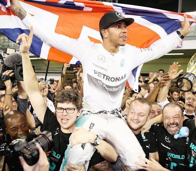Lewis Hamilton of Great Britain and Mercedes GP celebrates with his team