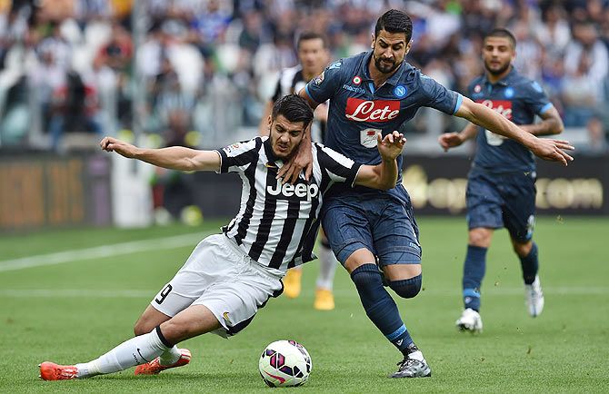 Juventus FC's Alvaro Morata (left) is tackled by SSC Napoli's Miguel Angel Britos during their Serie A match at Juventus Arena in Turin on Saturday