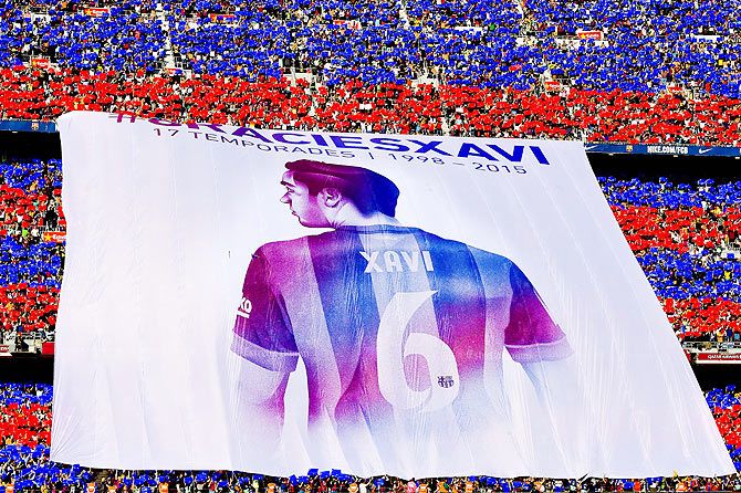 FC Barcelona fans display a huge banner tribute to Xavi Hernanez