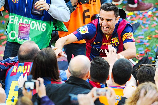 Xavi Hernandez knowledges fans at the end of the match