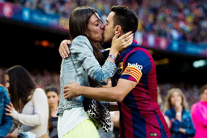 FC Barcelona's Xavi Hernandez kisses his wife Nuria Cunillera after the La Liga match against RC Deportivo La Coruna at Camp Nou in Barcelona on Saturday