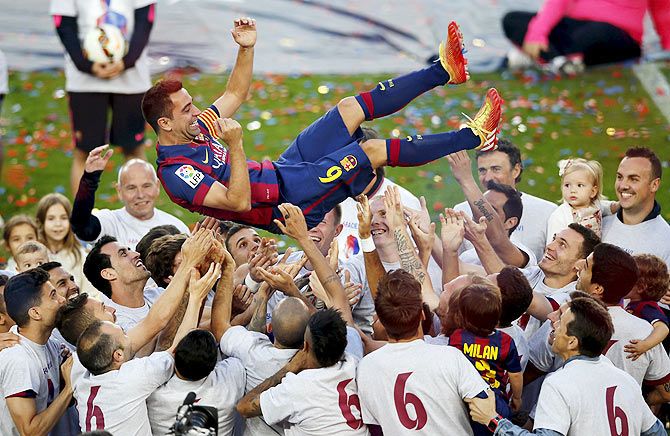 Barcelona's captain Xavi Hernandez is tossed by his teammates in his farewell celebration