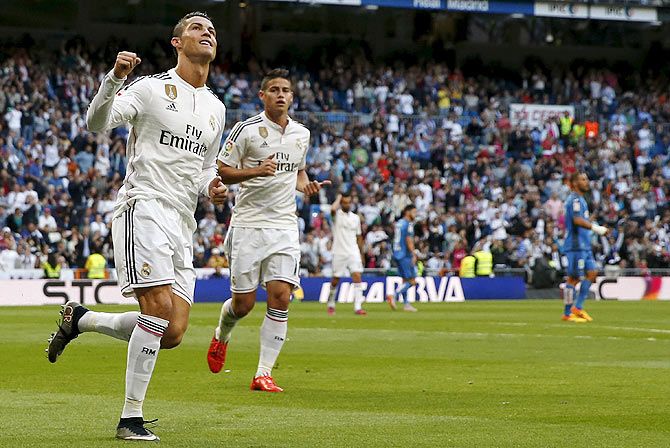 Real Madrid's Cristiano Ronaldo (left) celebrates his goal with teammate James Rodriguez during their La Liga match against Getafe at Santiago Bernabeu stadium in Madrid on Saturday
