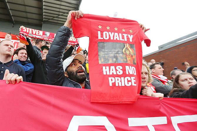 Liverpool fans hold out a poster on Steven Gerrard