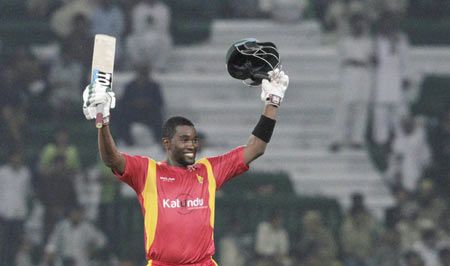 Zimbabwe's captain Elton Chigumbura celebrates his maiden ODI century during the first One-Day International against Pakistan at the Gaddafi Cricket Stadium in Lahore on Tuesday