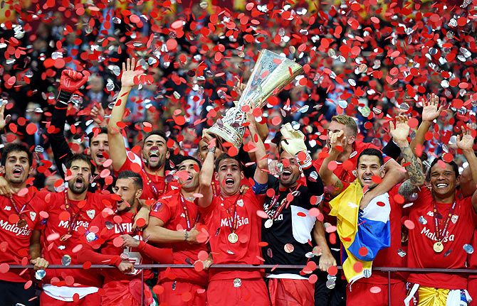 Sevilla's Fernando Navarro lifts the trophy after winning the UEFA Europa League final against FC Dnipro Dnipropetrovsk in Warsaw, Poland, on Wednesday
