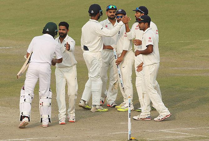 Players shake hands after the match 