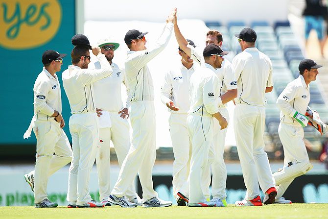 New Zealand's Matt Henry celebrates after taking the wicket of Australia's Joe Burns