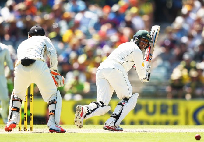 Australia's Usman Khawaja plays a shot towards fine-leg