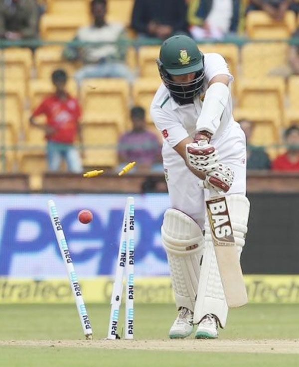 South Africa’s captain Hashim Amla is bowled by India’s Varun Aaron