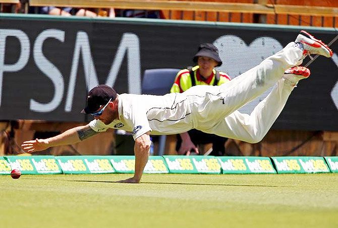 New Zealand's captain Brendon McCullum dives to stop a boundary