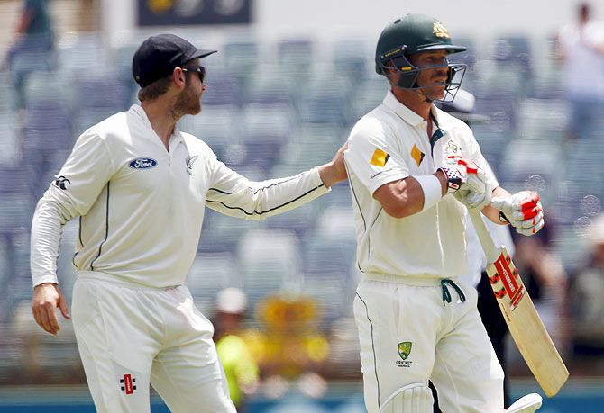 New Zealand's Kane Williamson (left) pats Australia's David Warner on the back as he walks off the ground after being dismissed for 253 runs