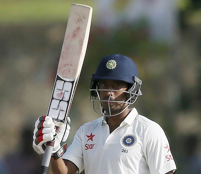 Wriddhiman Saha raises his bat to celebrate his half century on the second day of the first Test against Sri Lanka, in Galle, on August 13