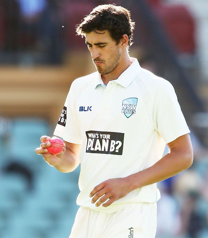 Mitchell Starc of the Blues inspects the pink ball during day three of the Sheffield Shield match between South Australia and New South Wales at Adelaide Oval on October 30