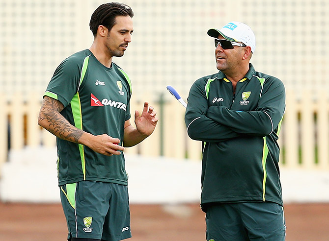Mitchell Johnson of Australia speaks to coach Darren Lehmann during a camp in Sydney 