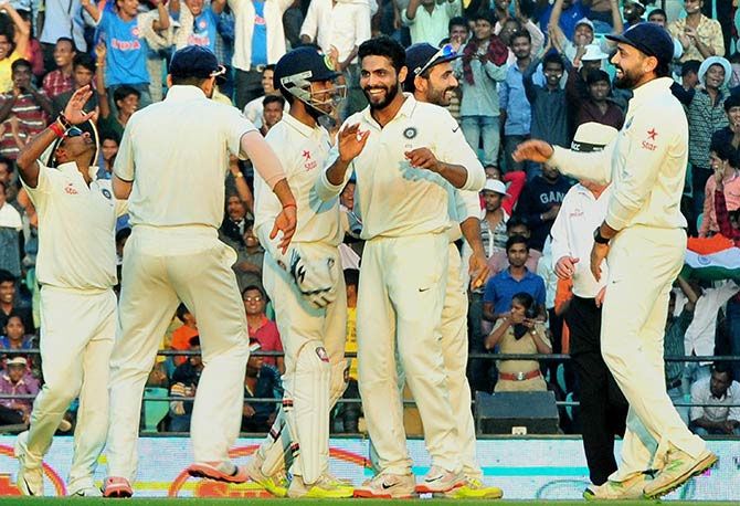Ravindra Jadeja celebrates with his teammates after taking the wicket of South Africa's Imran Tahir